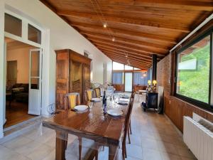 a dining room with a wooden table and chairs at Charmant gîte pour 6 personnes à Néronde - FR-1-496-357 