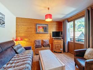 a living room with a couch and a table at Appartement 6 pers à La Clusaz, balcon et wifi - FR-1-818-103 in La Clusaz