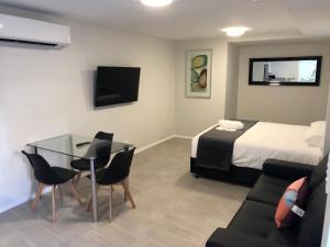 a hotel room with a bed and a table and chairs at LUX Jesmond in Jesmond