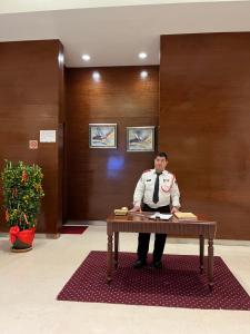 a man standing behind a table in a lobby at Max Suites At Barjaya Times Square Kl in Kuala Lumpur +47 photos