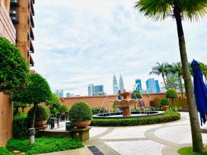 a fountain in a courtyard with a city in the background at Max Suites At Barjaya Times Square Kl in Kuala Lumpur