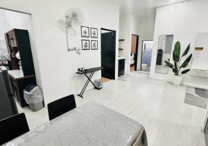 a room with a table and a potted plant at DVillage Homestay Kelantan Kota Bharu Free Wifi Bilik Aircond in Kota Bharu