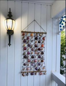 a rack of wine bottles on a wall with a light at Perfect Family Vacation at Bethany Beach Cottages! in Bethany Beach