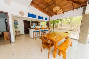 a dining room with a wooden table and chairs at Casa Majahualt in San Juan del Sur