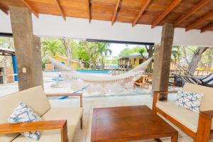 a living room with a hammock and a pool at Casa Majahualt in San Juan del Sur