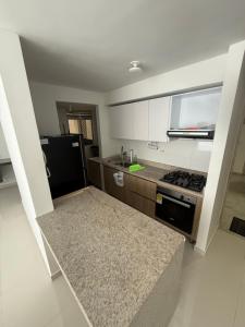a kitchen with a black refrigerator and a stove at Apartamento norte de Barranquilla in Barranquilla +5 photos