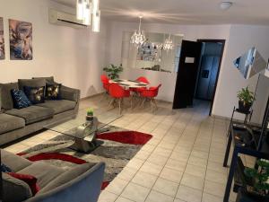 a living room with a couch and a table and chairs at Un hogar lejos de Casa in Monterrey