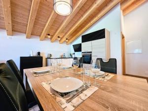 a dining room with a table with glasses on it at Chalet Eigernordwand in Grindelwald +14 photos