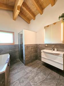a bathroom with a sink and a shower at Chalet Eigernordwand in Grindelwald