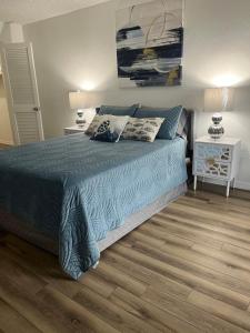 a bedroom with a bed with a blue comforter at Marazul in Cape Coral