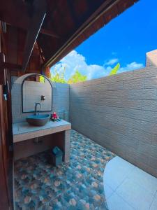 a bathroom with a sink and a mirror at Harta Lembongan Villas in Nusa Lembongan +81 photos