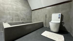 a bathroom with a bath tub and a toilet at Sigiri Veenus Tree House in Sigiriya +23 photos