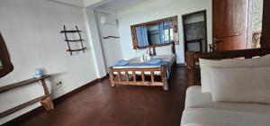 a room with a bedroom with a bed and a table at Ella Mount View Guest Inn in Ella