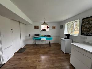 a kitchen with a blue table in the middle of a room at Surrey central in Surrey