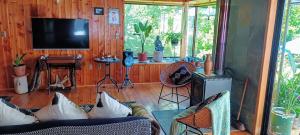 a living room with a couch and a television at Casa RamLe in Pucón