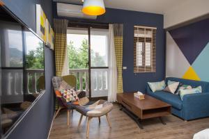 a living room with a blue couch and a table at Salmon B&B in Hualien City