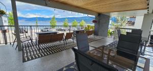 a patio with a table and chairs on a balcony at Okanagan Lakefront Resort in Penticton