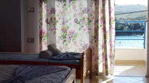 a bedroom with a bed and a window with curtains at Apartments Neri in Ksamil