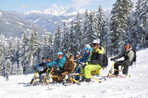 a group of people posing for a picture on a ski slope at Erzberg Alpin Resort by ALPS RESORTS in Eisenerz +98 photos