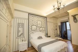 a bedroom with a bed and a brick wall at Salmon B&B in Hualien City