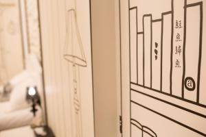 a close up of a bathroom door with a mirror at Salmon B&B in Hualien City