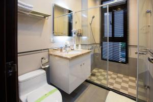 a bathroom with a toilet and a sink and a shower at Salmon B&B in Hualien City