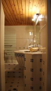 a bathroom with a sink and a mirror at Chios Stone House in Chios