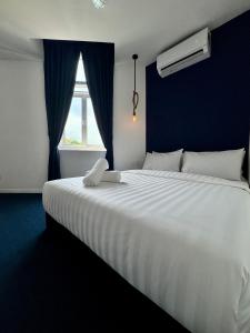 a large white bed in a room with a window at The Harbour by Moonknight in George Town