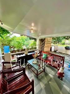 a living room with two benches and a table at Villa Thalia Staycation hub in Cogeo Village