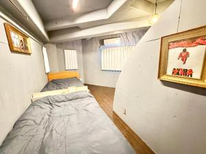 Llit o llits en una habitació de 沙羅居Soho名古屋駅前