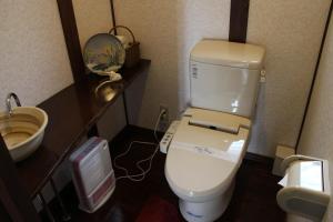 a small bathroom with a toilet and a sink at Yufuin-Sanso Waremokou in Yufu +113 photos