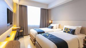 Yellow Star Gejayan Hotelにあるベッド
