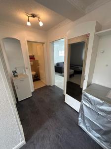 an empty room with a bed and a room with a mirror at Ruhige geräumige Wohnung in Pforzheim +5 photos