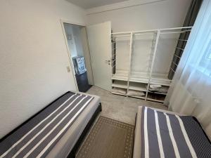 a small room with two beds and a closet at Ruhige geräumige Wohnung in Pforzheim