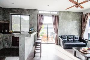 a living room with a bar and a couch at Alphabeto Resort in Nai Harn Beach