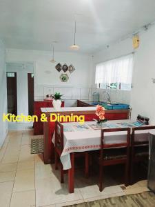 a kitchen and dining room with a table and chairs at Grace Homestay in Rewasau +5 photos