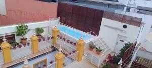 an overhead view of a building with a swimming pool at Las Casas de El Arenal in Seville
