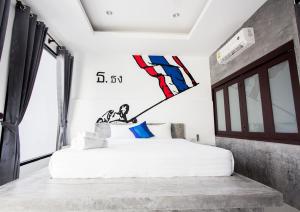 a bedroom with a bed with a kite on the wall at Alphabeto Resort in Nai Harn Beach +21 photos