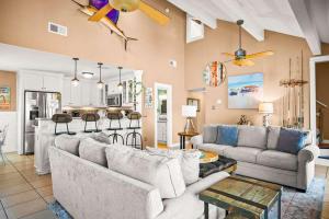 a living room with two couches and a kitchen at Coastal Casa in Port Aransas +60 photos
