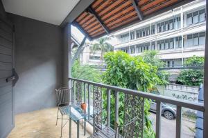 a balcony with a table and a building at Sabaidee Chiangmai Hotel in Chiang Mai