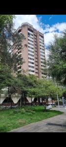 a tall building with trees in front of it at French Suite Cordero, amazing view, internet veloz in Quito
