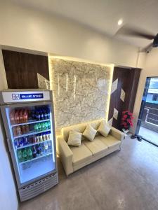 a living room with a couch and a drink cooler at Hotel The Ceremony in Kalyan