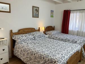 a bedroom with two beds and a window at 3 Dunrobin Street in Tain