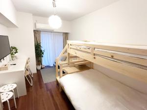 Postel nebo postele na pokoji v ubytování Suke Home Oshiage