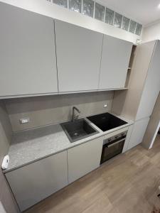 a kitchen with white cabinets and a sink at Echoes in Campobasso +8 photos