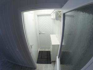 a bathroom with a walk in shower next to a door at Villa Terveenniemi in Kontula