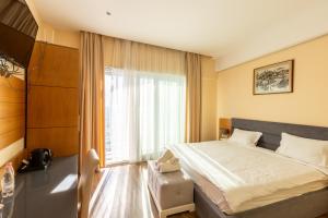 Postel nebo postele na pokoji v ubytování Ventus Harbor Hotel