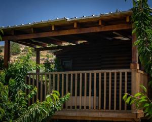 a wooden deck with a wooden pergola at וידה בחרמון שביל הגולן- בקתת 2 חדרי שינה וסלון בלב מטע דובדבנים in Majdal Shams