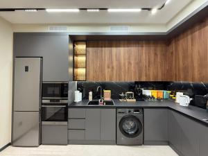 a kitchen with a washing machine and a washer at Buston City in Dushanbe