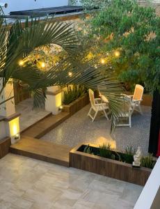 a courtyard with chairs and lights in a building at Eco-Hotel Black Tree in Mazatlán